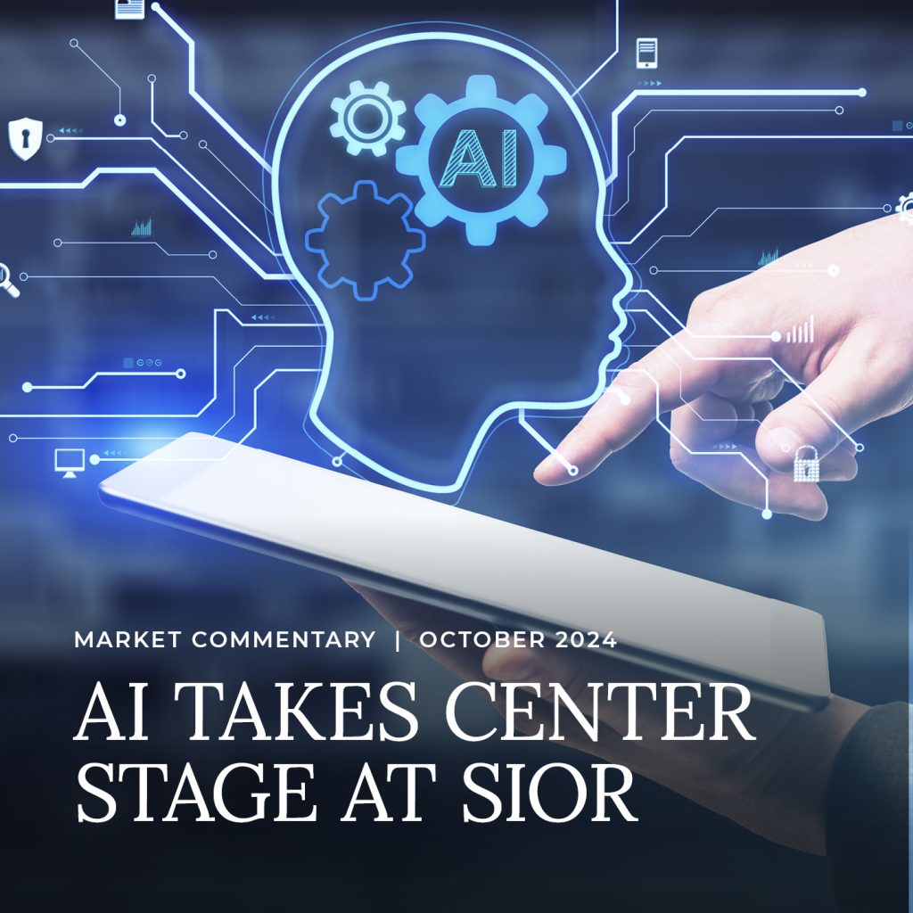 A person uses a tablet with a digital overlay of a human head, gears, and AI symbols; text reads "AI Takes Center Stage at SIOR, October 2024.