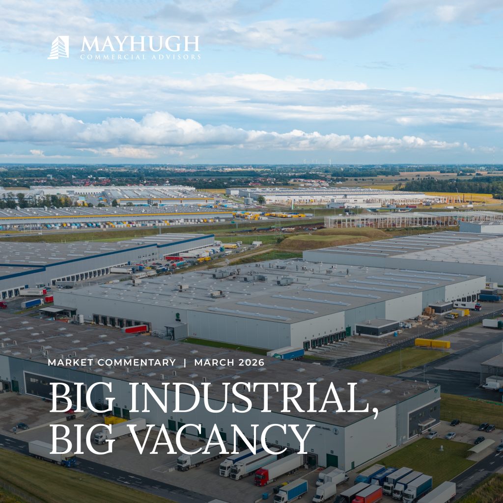 Aerial view of a large industrial complex with many warehouses and parking lots, accompanied by the headline "Big Industrial, Big Vacancy.