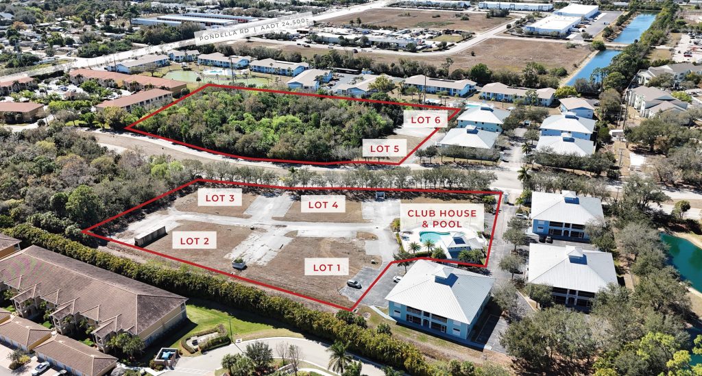 Aerial view of a residential development site with six labeled lots, a clubhouse and pool, and surrounding buildings and roads.