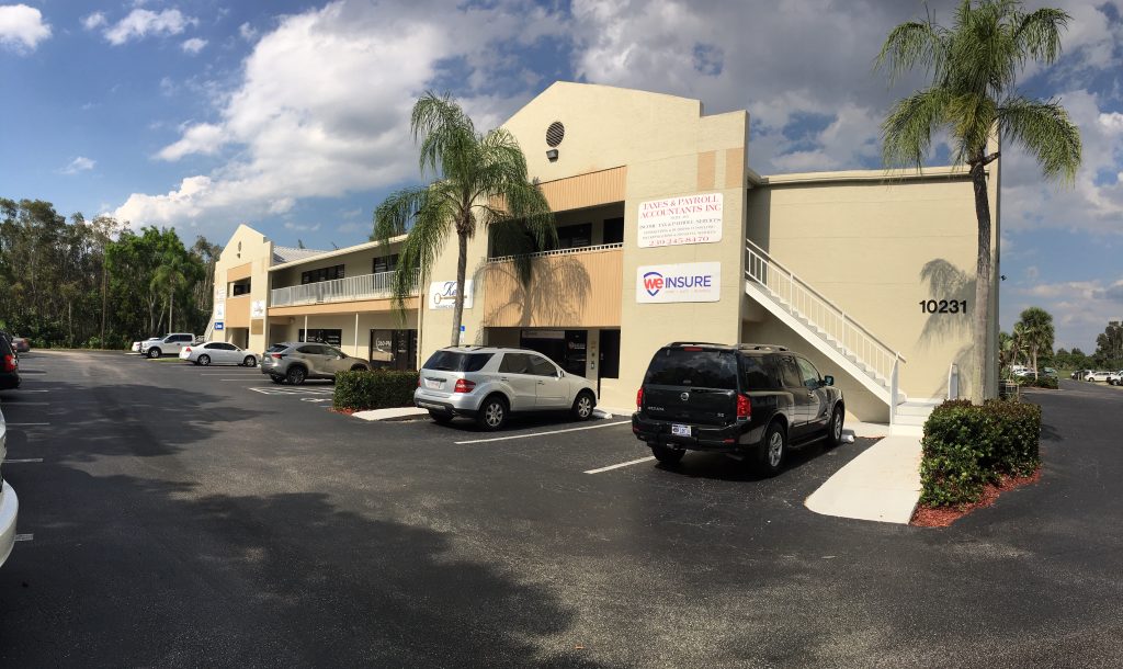 A two-story beige office building with palm trees, several parked cars, exterior stairs, and business signs, including “WE INSURE” and “10231” on the front.