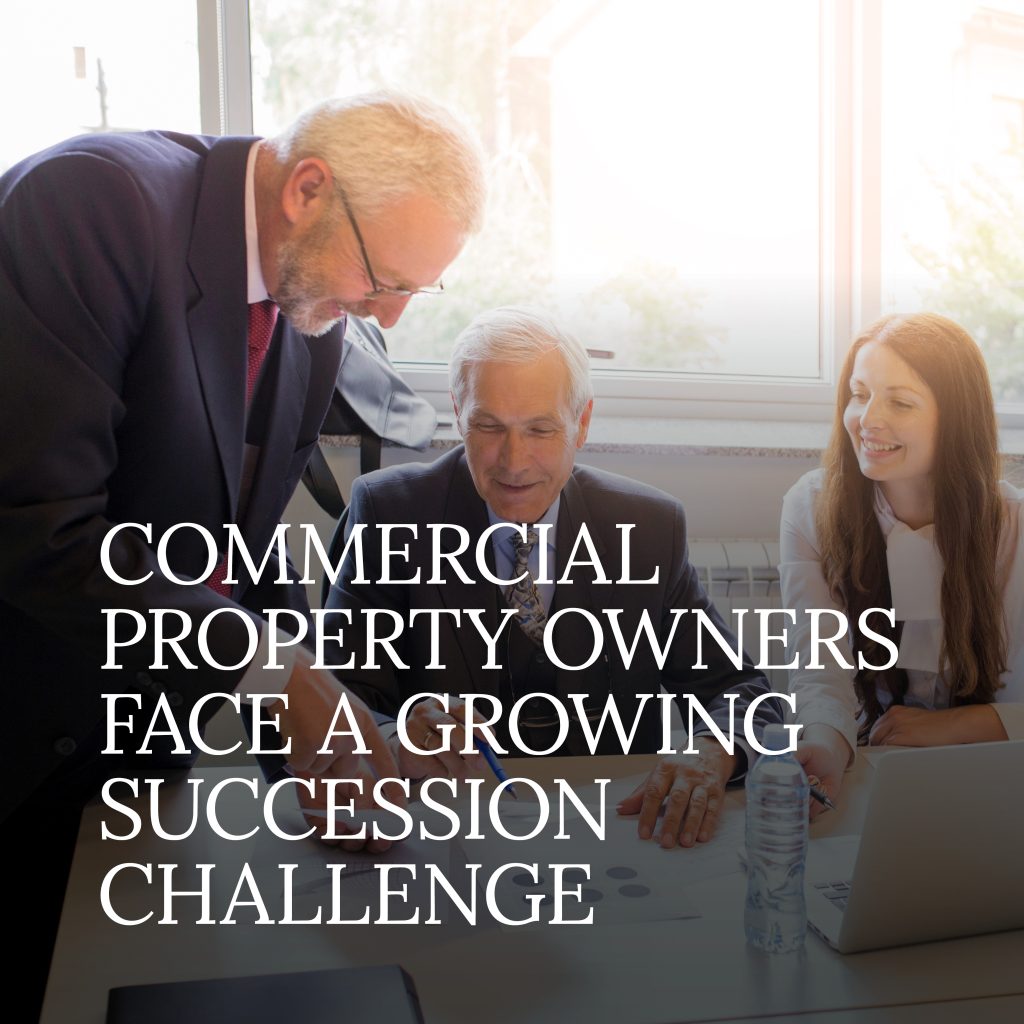 Three professionals meet at a table with documents and a laptop, discussing business, with text about commercial property owners facing succession challenges.